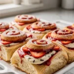 Strawberry vanilla cream rolls with soft swirls, creamy vanilla filling, and sweet strawberry layers